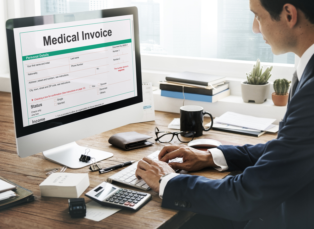 Medical billing and coding professional documenting medical invoice